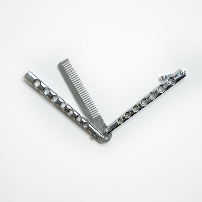 Comb-style balisong trainer used to practice butterfly knife handling techniques and tricks safely