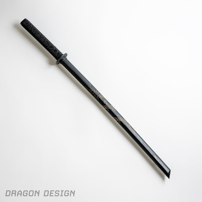 A Japanese training sword, bokken, with black wood and an etched dragon design.