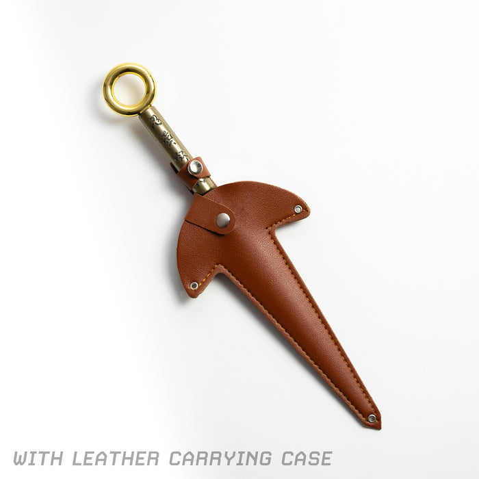 Flying Thunder God Kunai - a golden and black kunai inside of the brown leather carrying case.
