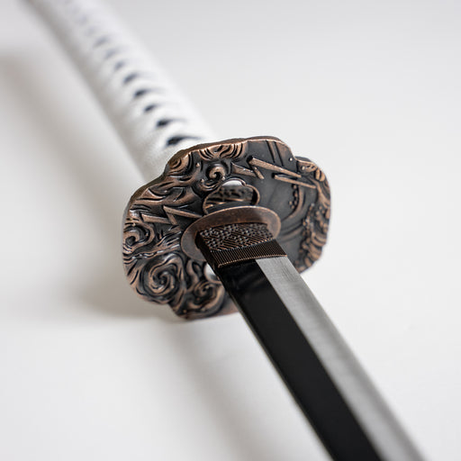 Closeup of the lightning motifs on Jin Sakai’s sword’s guard.