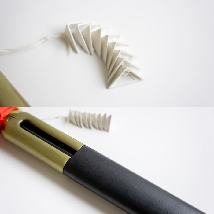 Closeups of the folded paper decoration and a sheathed benihime.