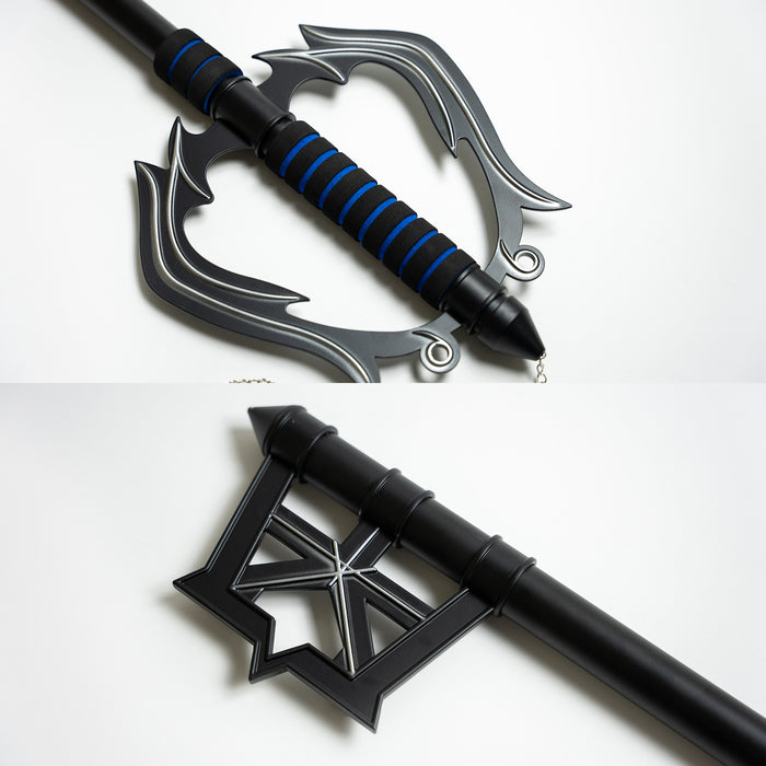 Details of A black and blue handle key blade from Kingdom Hearts video game series - with a metal crown on a chain dangling from the handle.