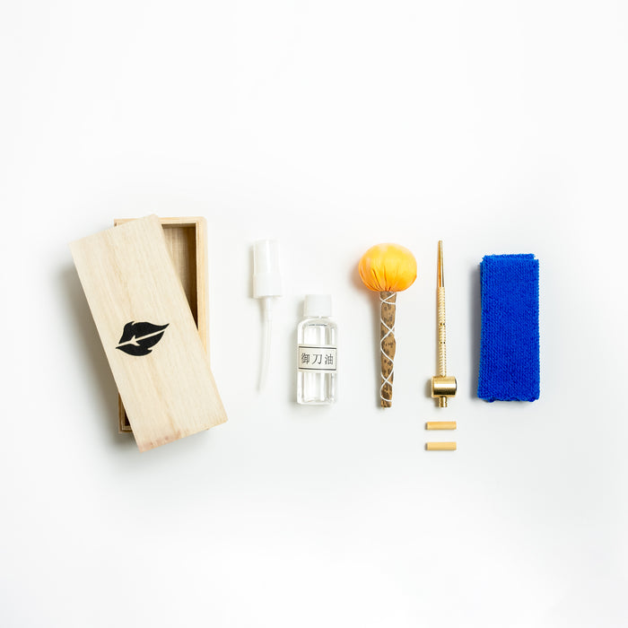 Lubricant Sword Care Kit from Fire and Steel. Includes a wooden box, cleaning cloth, uchiko ball, Mekugi-Nuki (hammer), spare Mekugi dowels and maintenance oil.