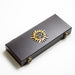 Details of the wooden case, featuring a sun motif and pentagram.