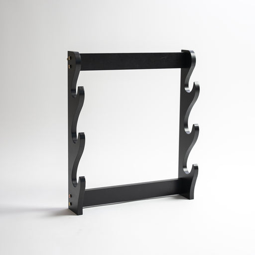 Triple wooden sword stand in black, with ability to stand upright or hang on the wall.
