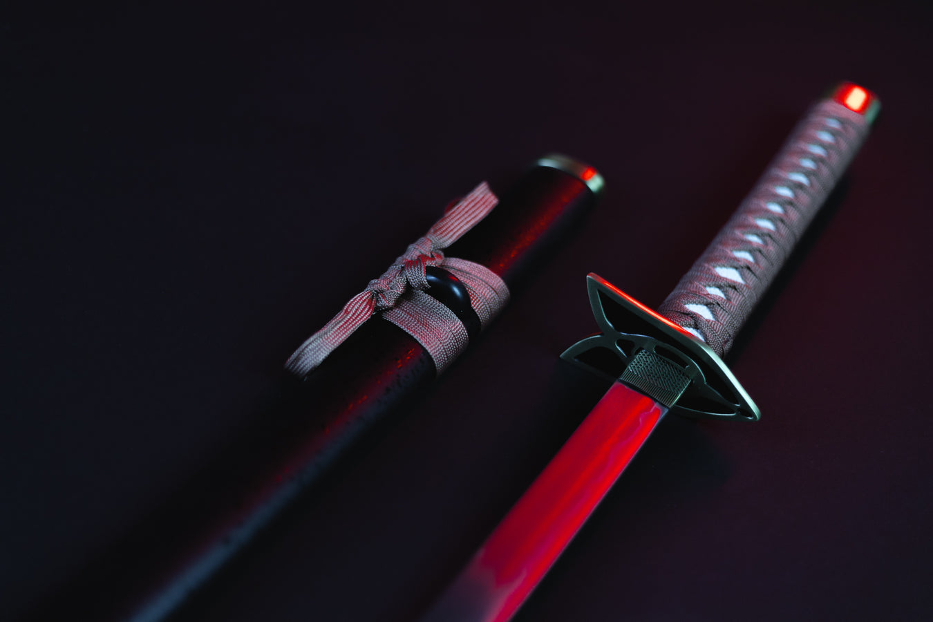 Rangiku's sword from Bleach on a dark background, lit up with a red light.