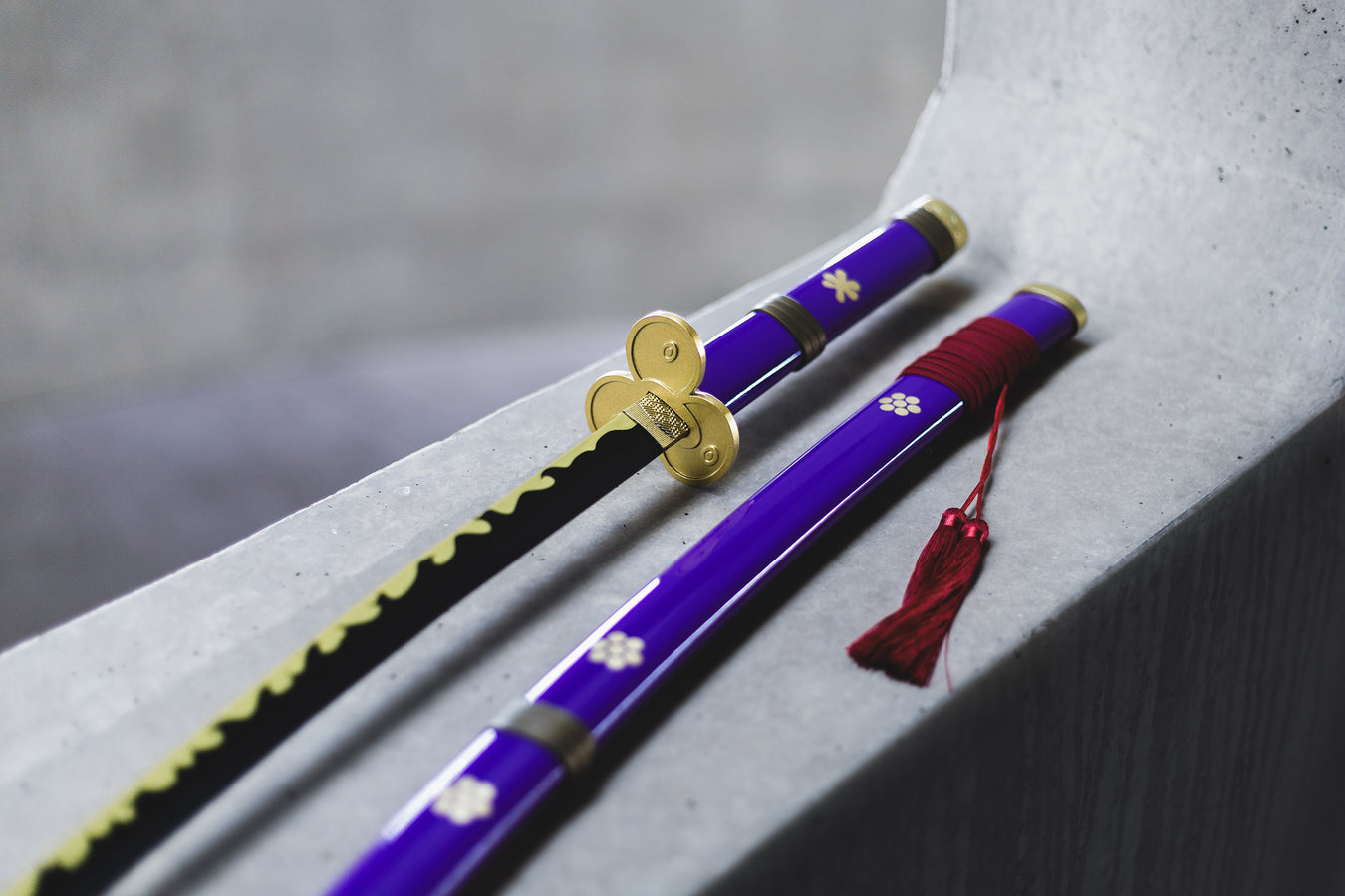 Zoro's purple enma sword and sheath on a concrete background.